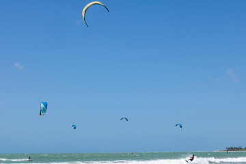 kite surfing in the sea with windmills in the background