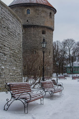 Fototapeta na wymiar Wooden benches near the historic wall in Tallinn's Old Town. Estonia