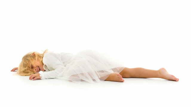 Little girl lies on the floor.Studio photo shoot on a white back