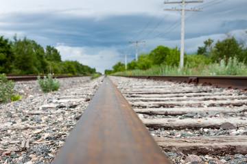 Fototapeta na wymiar Ground Level View of Rail and Weathered Railway Ties