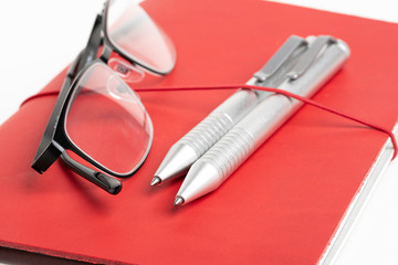 Red Leather Journal Cover With Pens And Glasses