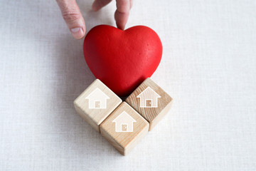 Doctor hand arranging wood block stacking with icon home healthcare, insurance for your health.