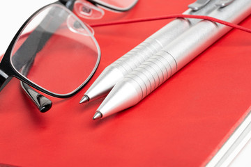 Red Leather Journal Cover With Pens And Glasses