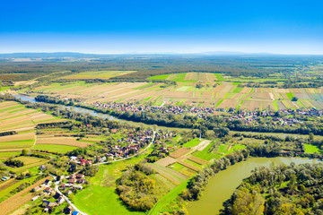 Fototapeta na wymiar Beautiful countryside landscape in Croatia, near Sisak, Sava river meandering between agriculture fields, aerial shot from drone