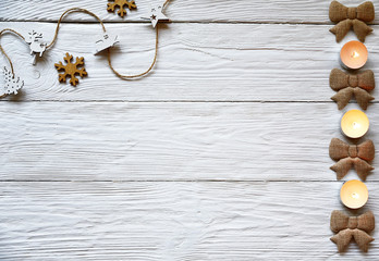 Christmas decorations and candles on a white wooden background. Festive background.