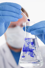 Fototapeta premium A male chemist holds test tube of glass