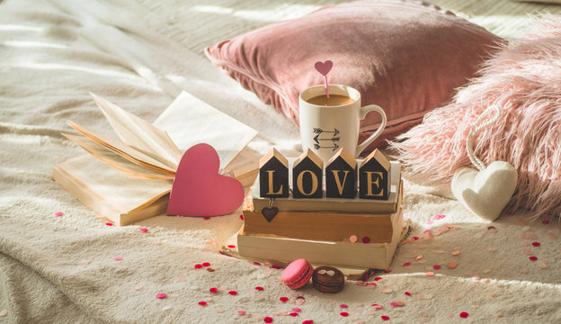 Happy Valentines Day postcard. Love concept for mothers day and valentines day. Hearts and the books with cup coffee