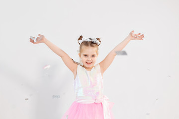 Party, holidays, birthday, new year and celebration concept - Cute child throwing confetti.