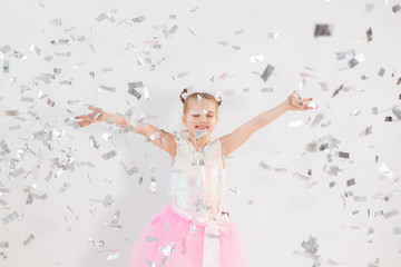 Party, holidays, birthday, new year and celebration concept - Cute child throwing confetti.