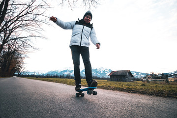 Fototapeta na wymiar Man Skateboarding On The Road, Liechtenstein.