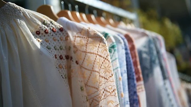 Embroidered peasant blouses, known as romanian traditional blouses, are seen at a Christmas fair 