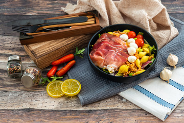 Salad made with cooked pasta, mixed green salads, cherry tomatoes, Mozzarella cheese and smoked ham served with accompaniment