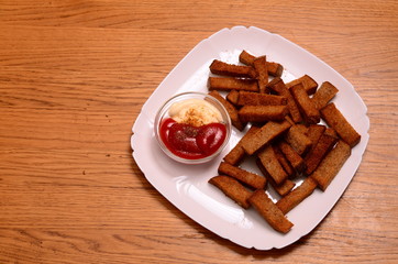 crackers from bread and salt and laurel on wooden background