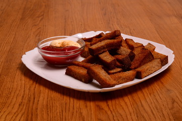 crackers from bread and salt and laurel on wooden background