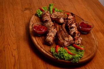 Sliced grilled beef barbecue Striploin steak with chimichurri sauce on cutting board on dark wooden background