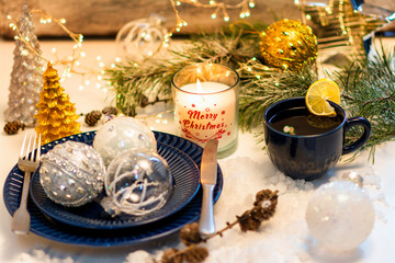 Exposition of Christmas candles light, hot tea, blue plate, its beautiful day, Merry Christmas the best day in the year.
