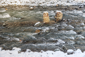 mountain river with two old concrete piles