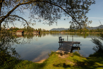 evening mood in autumn by the lake with a bench for relaxation