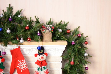 White fireplace decorated for Christmas new year fir tree branch.