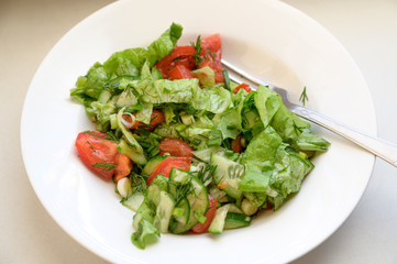 Salad with olives, tomatoes and cucumber.