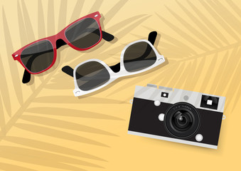 Sunglasses and camera on beach