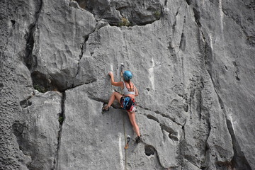 Beautiful girl climbing rock