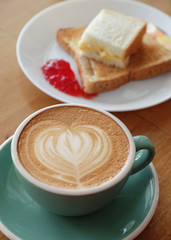 hot latte coffee with bread and strawberry jam