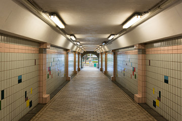 a pathway in a tunnel that decorated with tiles