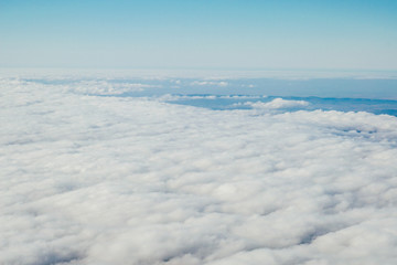 blue sky above white clouds from inside the plane