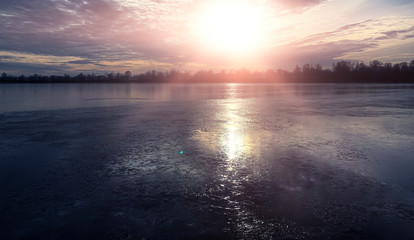 Winter landscape, landscape with a river and sunny sunset. Natural background, winter background.