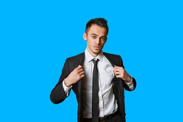 Portrait of a confident young businessman over colored background