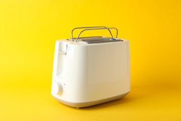 Toaster for bread on yellow background, space for text