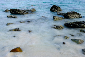 Waves hitting stones at the beach.