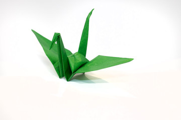 Origami green crane - Isolated on white background