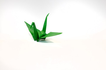 Origami green crane - Isolated on white background