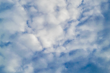 Background with blue sky and many clouds. A lot of little white clouds.