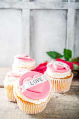 Valentine's day greeting card. Sweet Valentine's creative dessert food. Homemade pink and red  delicious cupcakes with decor of Valentine day symbols