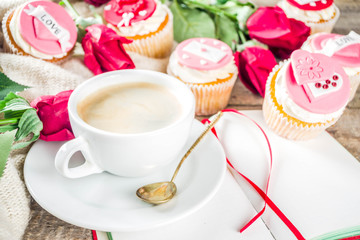 Valentine morning sweetheart scene. Breakfast on Valentine's Day February 14th. Sweet creative cupcakes with whipped cream and decor love, Valentine symbols. Mockup flatlay top view copy space
