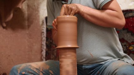  Avanos, Turkey - 29 July 2019: Man making ceramic clay pot on the potter's wheel.