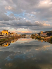 Fototapeta na wymiar Clouds reflected in the Arno river in the city of Florence
