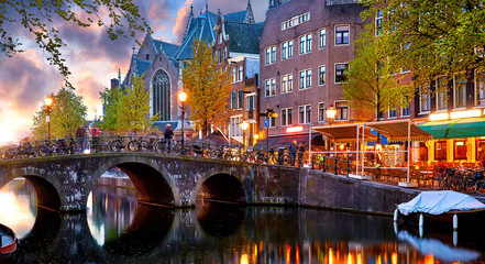 Red-light district in Amsterdam city picturesque landscape panorama evening town with pink sunset...