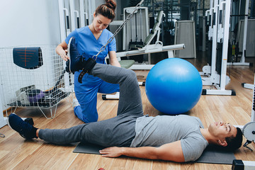 Kinesitherapist training with a male patient of mixed race. The treatment of osteochondritis, joint pain, kinesitherapy exercises