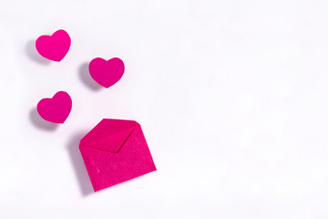 Valentine's day composition. Purple envelope on white paper background.