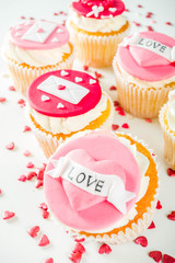 Valentine's day greeting card. Sweet Valentine's creative dessert food. Homemade pink and red  delicious cupcakes with decor of Valentine day symbols