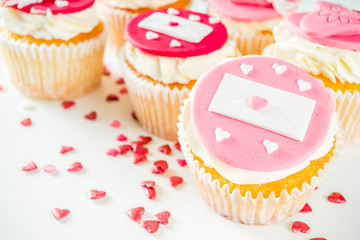 Valentine's day greeting card. Sweet Valentine's creative dessert food. Homemade pink and red  delicious cupcakes with decor of Valentine day symbols