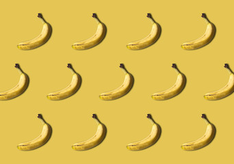 Fototapeta na wymiar Bananas pattern isolated on yellow background. Summer fruit.
