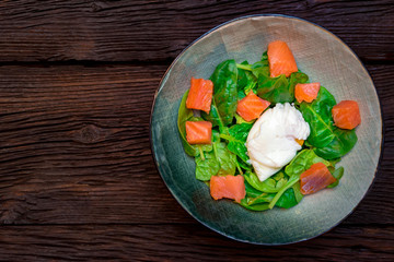 Top view plate with salmon salad with poached egg