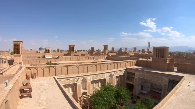 Yazd, Iran - May 2019: Yazd cityscape with old brick buildings and badgirs wind catching towers in Yazd, Iran.