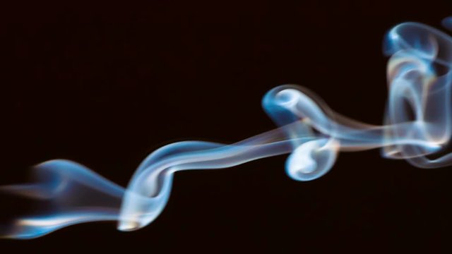Trembling Jet Stream Smoke. A thin stream of smoke curls into bizarre shapes and fills the space. Filmed at a speed of 120fps