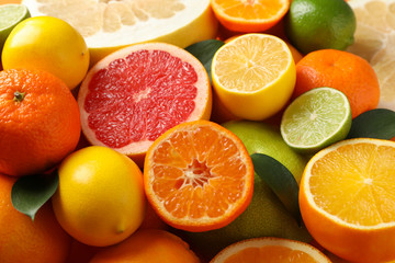 Juicy citrus fruits textured background, close up